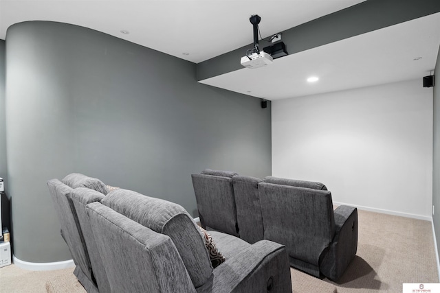 cinema room with light colored carpet and baseboards