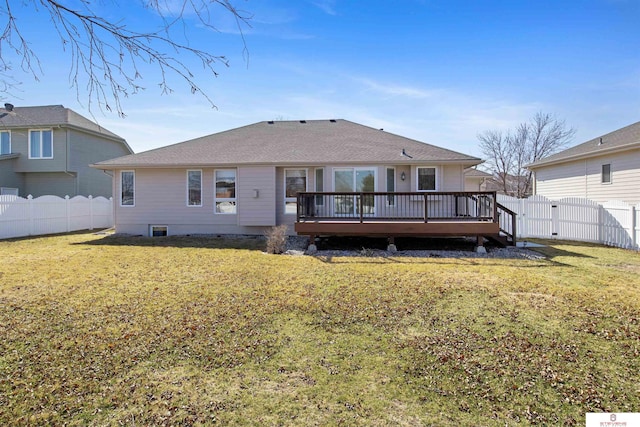 rear view of property featuring a deck, a gate, a fenced backyard, and a yard