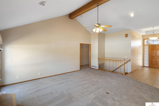 unfurnished living room with visible vents, carpet floors, beam ceiling, high vaulted ceiling, and a ceiling fan