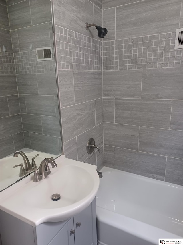 full bath featuring vanity and shower / bathtub combination