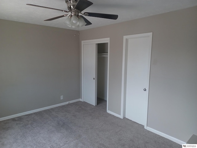 unfurnished bedroom featuring a closet, carpet flooring, ceiling fan, and baseboards