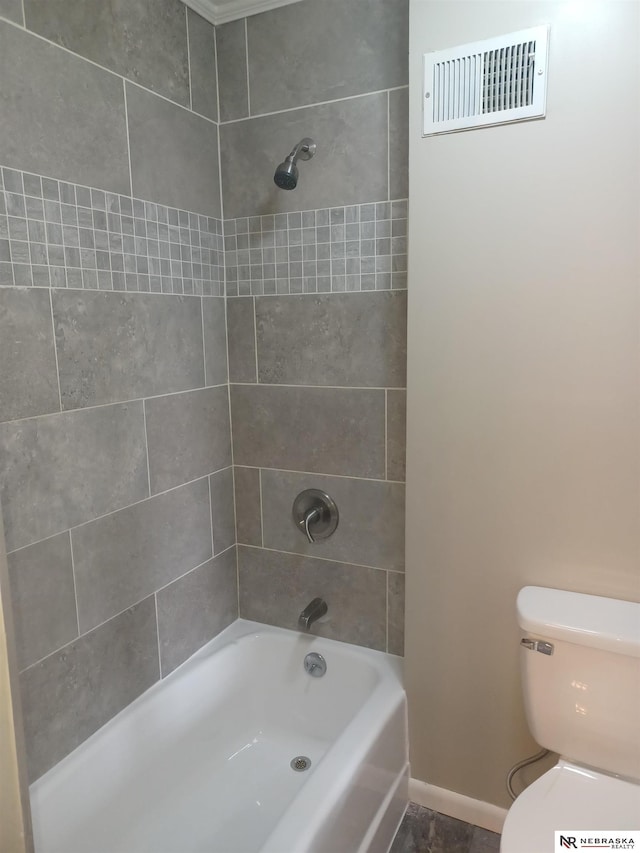 bathroom with baseboards, visible vents, toilet, and  shower combination