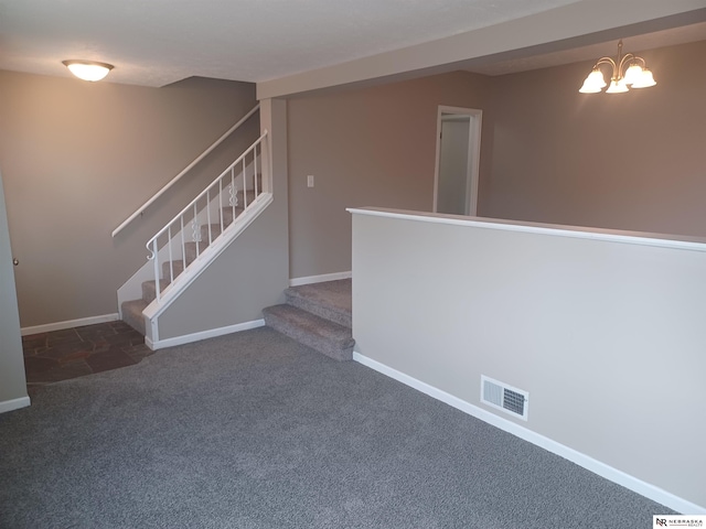 stairway with carpet flooring, baseboards, visible vents, and a chandelier