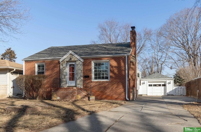 view of front facade with fence, an outdoor structure, concrete driveway, brick siding, and a chimney