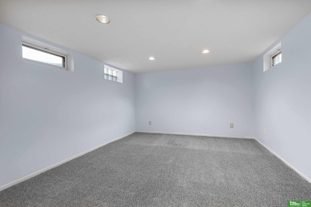 basement featuring baseboards, a wealth of natural light, and carpet floors