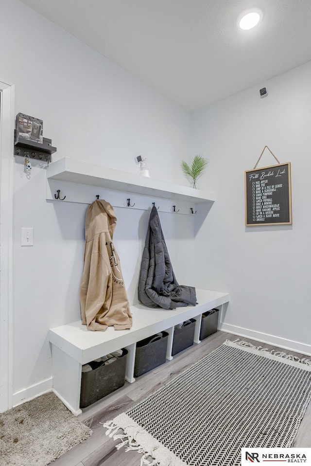 mudroom with wood finished floors and baseboards