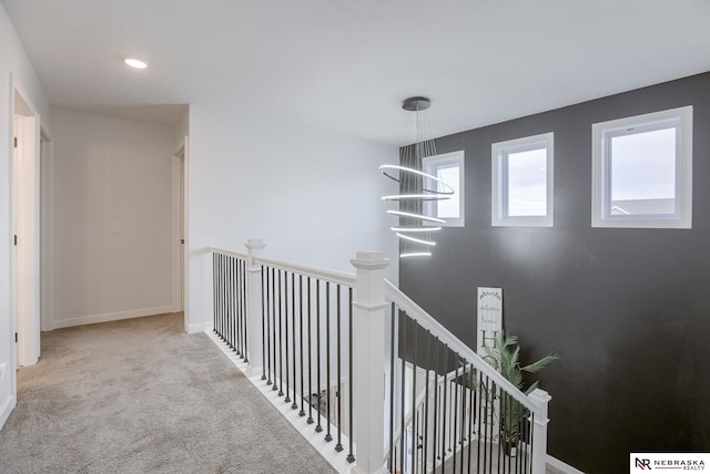 hallway featuring recessed lighting, an upstairs landing, baseboards, and carpet floors