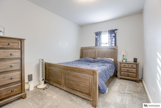 bedroom featuring baseboards and light carpet