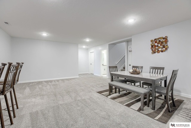 carpeted dining room with visible vents, stairway, recessed lighting, and baseboards