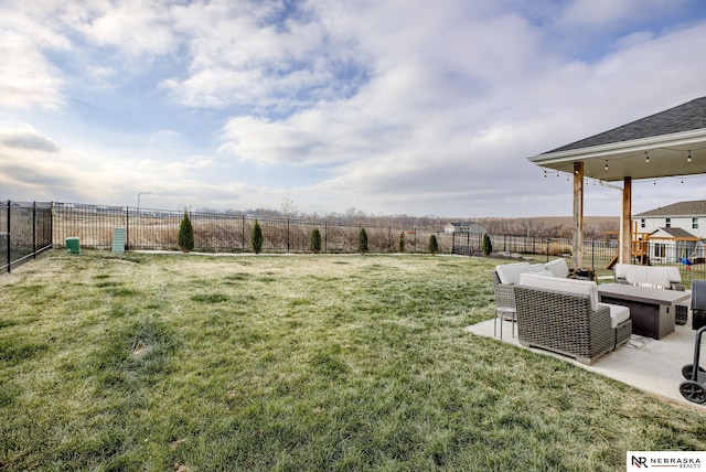 view of yard with an outdoor living space, a patio, a rural view, and a fenced backyard