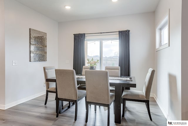 dining area featuring recessed lighting, baseboards, and wood finished floors