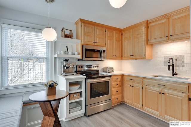 kitchen featuring a sink, light brown cabinetry, light countertops, appliances with stainless steel finishes, and open shelves