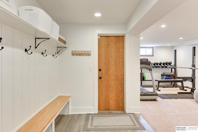 mudroom with recessed lighting, baseboards, and wood finished floors