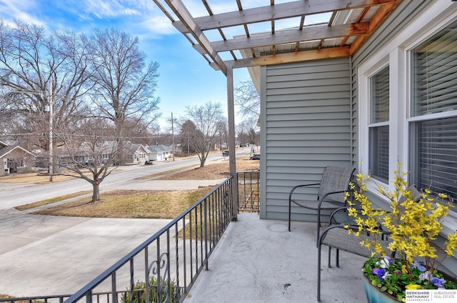 balcony featuring a pergola