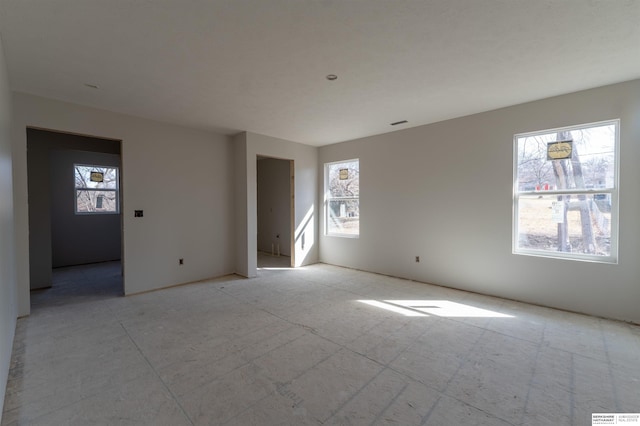 unfurnished room with visible vents