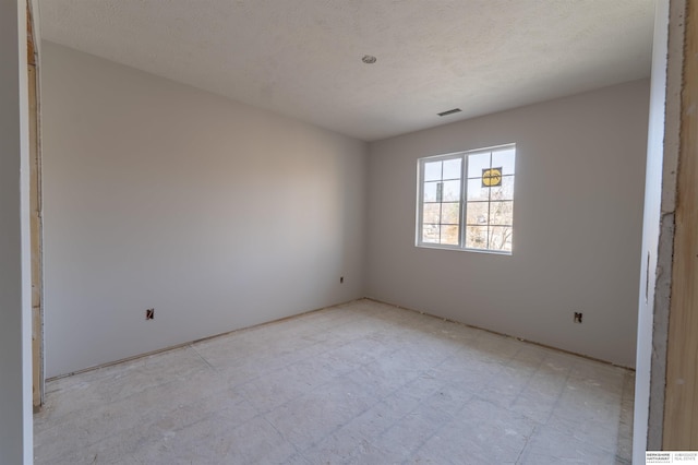 empty room with light floors and visible vents