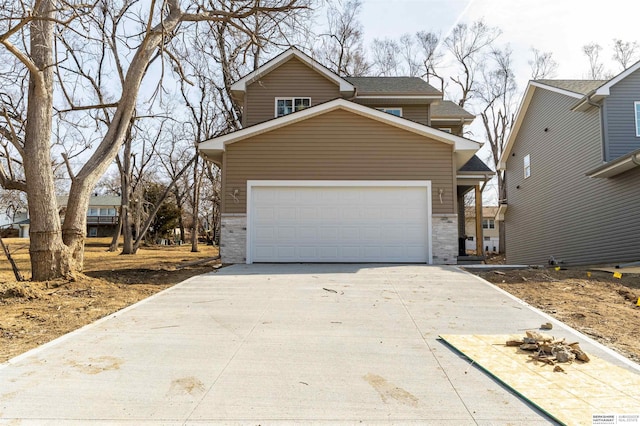 traditional-style house featuring an attached garage and concrete driveway