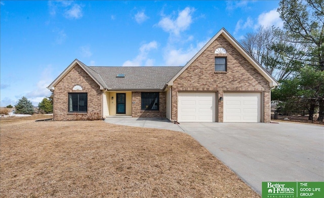 view of front facade featuring brick siding, concrete driveway, a garage, and a shingled roof