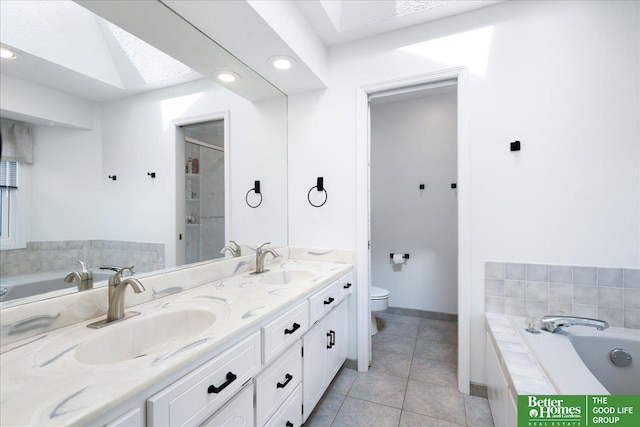 bathroom featuring a sink, toilet, and a bath