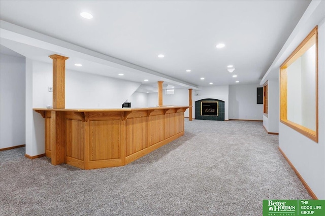 bar with indoor wet bar, recessed lighting, light colored carpet, and baseboards