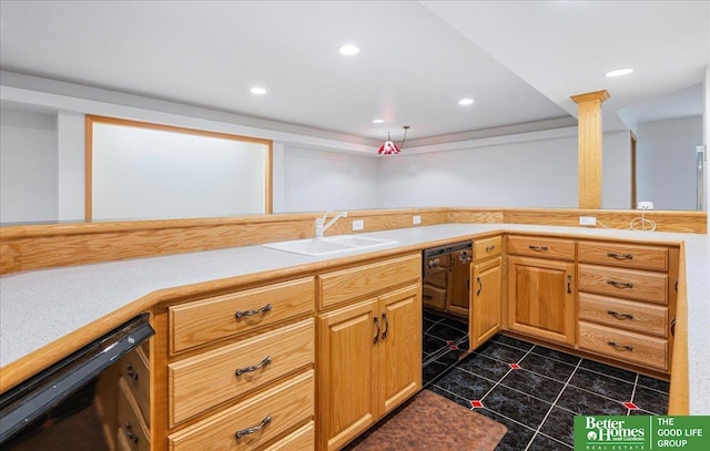 kitchen with light countertops, black dishwasher, and a sink