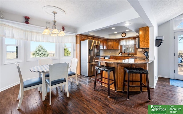 dining area with baseboards, an inviting chandelier, and dark wood-style floors