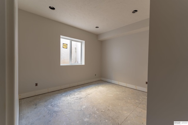 empty room featuring baseboards