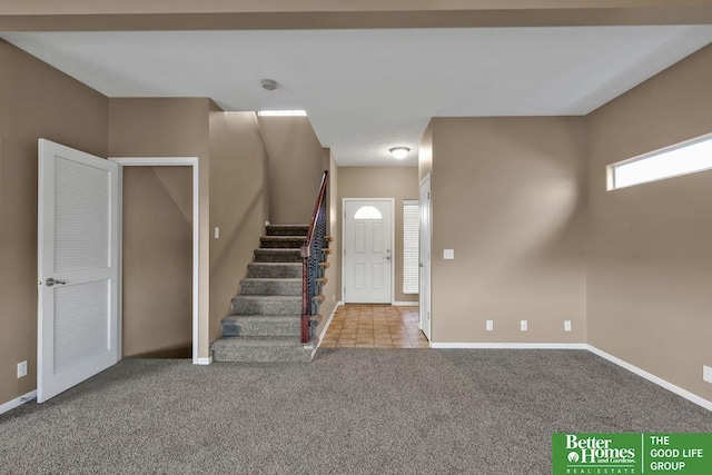 entrance foyer featuring stairway, carpet floors, and baseboards