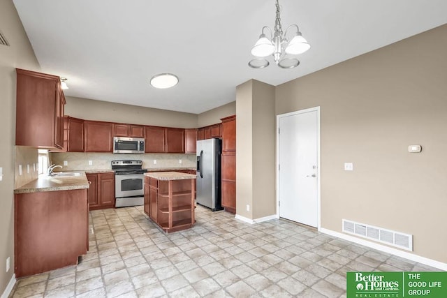 kitchen featuring visible vents, a sink, tasteful backsplash, stainless steel appliances, and light countertops