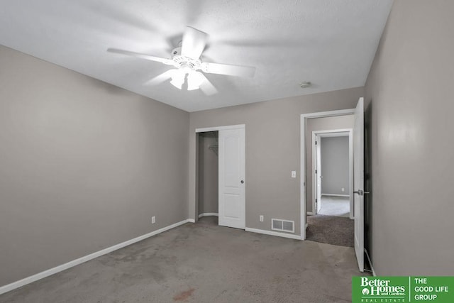 unfurnished bedroom with visible vents, a closet, carpet, baseboards, and ceiling fan