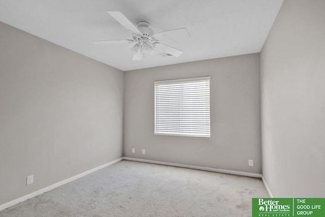 spare room with visible vents, carpet floors, baseboards, and ceiling fan