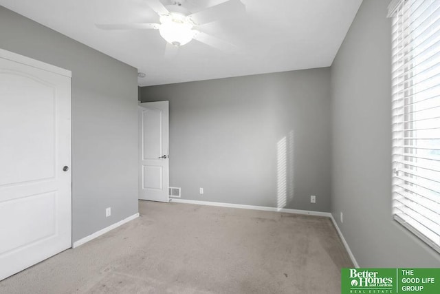 unfurnished bedroom with multiple windows, baseboards, and visible vents