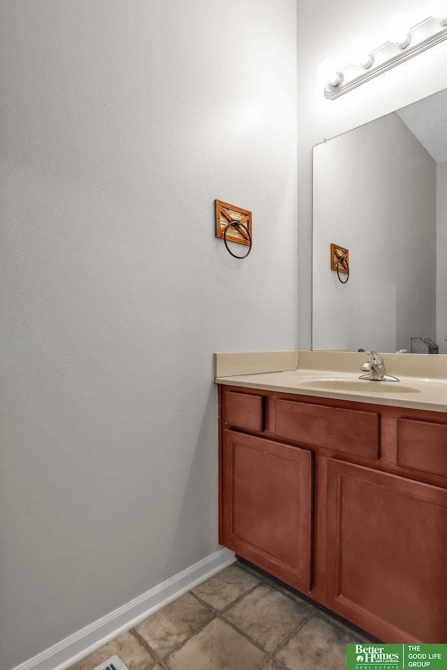 bathroom with vanity and baseboards