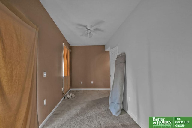 carpeted empty room with baseboards and ceiling fan