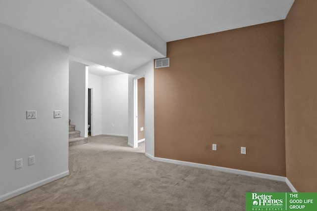 empty room with visible vents, baseboards, stairway, carpet floors, and recessed lighting