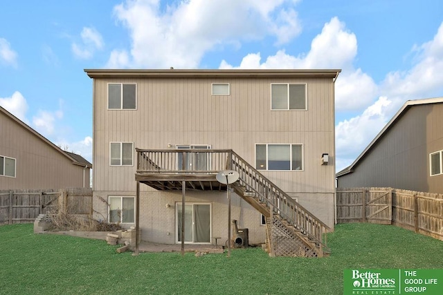 back of house featuring a yard, a wooden deck, a fenced backyard, and stairway