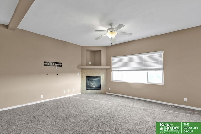 unfurnished living room with visible vents, baseboards, ceiling fan, carpet floors, and a fireplace