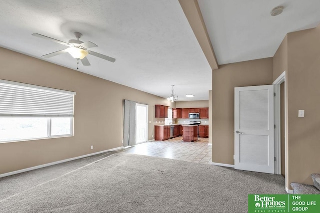 unfurnished living room with baseboards, light colored carpet, and ceiling fan