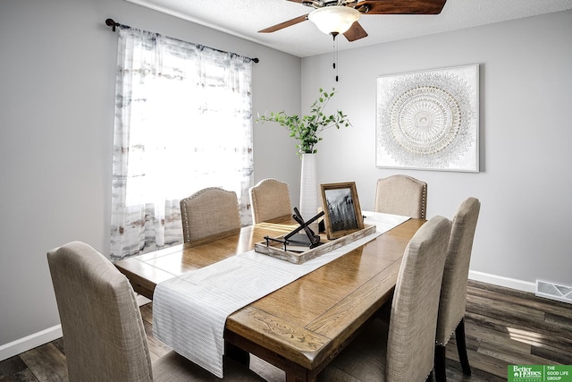 dining space featuring visible vents, baseboards, ceiling fan, and wood finished floors