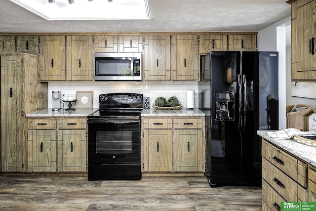 kitchen featuring backsplash, black appliances, wood finished floors, brown cabinetry, and a textured ceiling