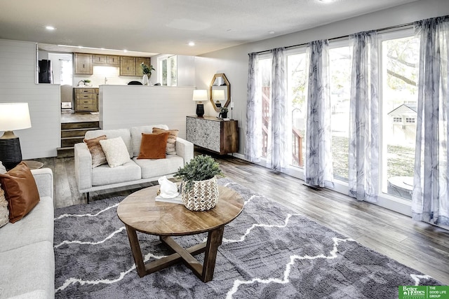 living area with recessed lighting and wood finished floors