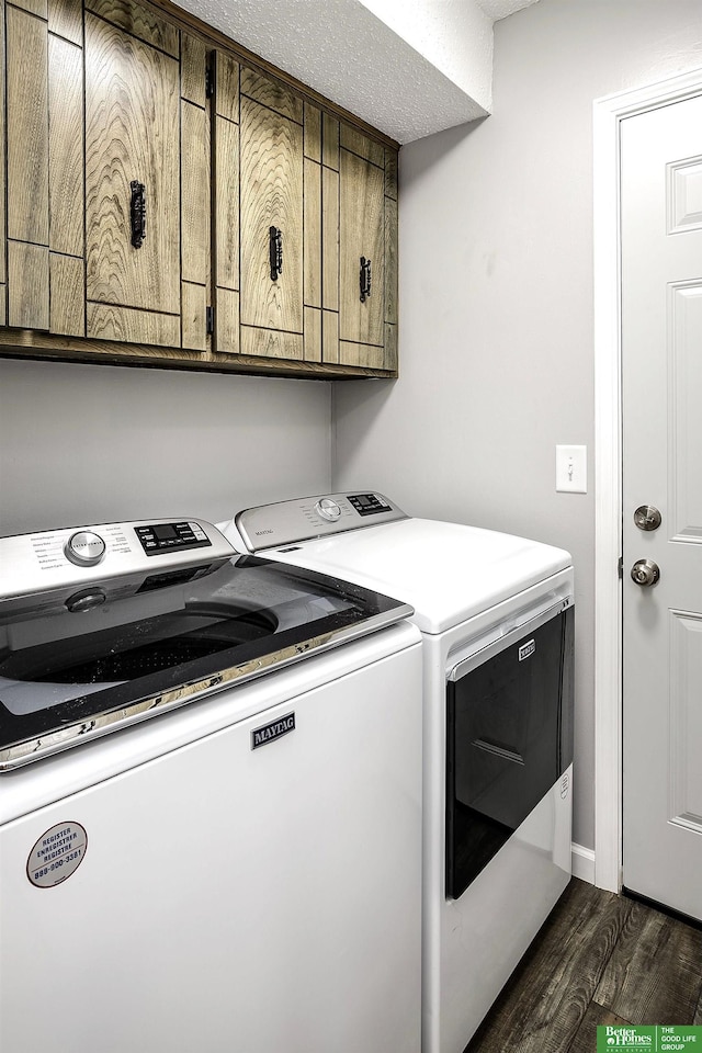 laundry area with dark wood finished floors, cabinet space, and independent washer and dryer