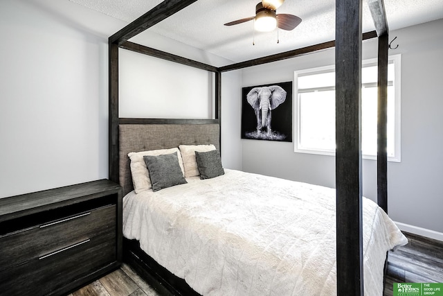 bedroom featuring a textured ceiling, wood finished floors, and a ceiling fan