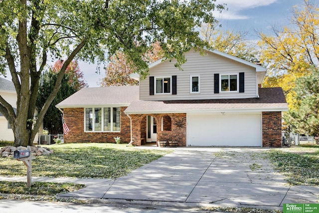 tri-level home with brick siding, central air condition unit, an attached garage, and concrete driveway