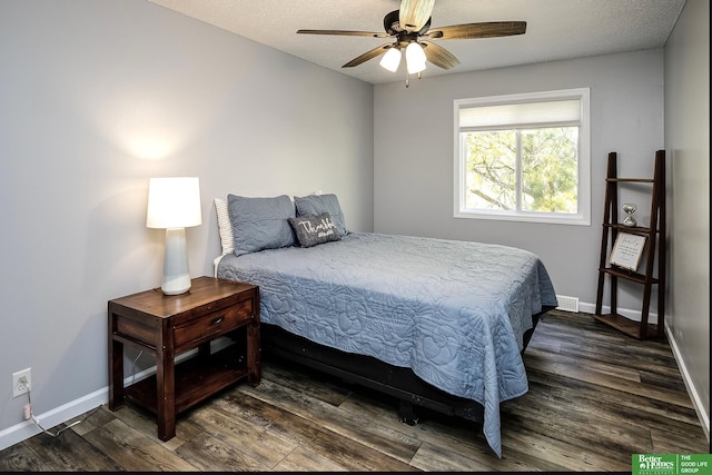 bedroom with dark wood-type flooring and baseboards