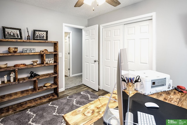 bedroom with a ceiling fan, a textured ceiling, wood finished floors, a closet, and baseboards