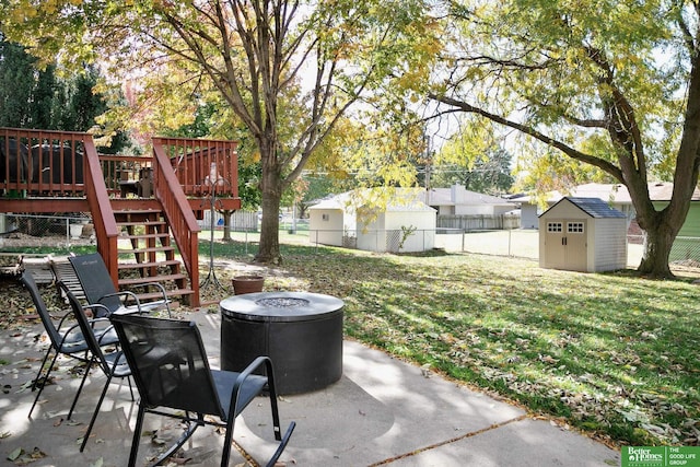 view of patio / terrace with stairway, fence, an outdoor structure, a deck, and a storage shed