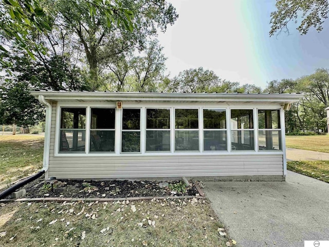 view of side of home featuring a sunroom