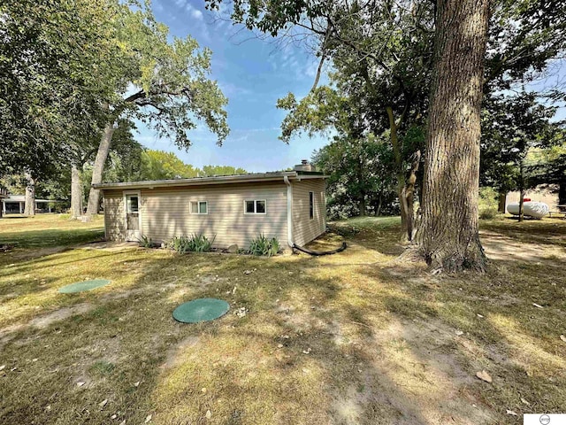 exterior space featuring a yard and a chimney