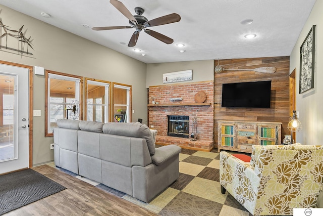 living area featuring recessed lighting, a brick fireplace, ceiling fan, and wood finished floors